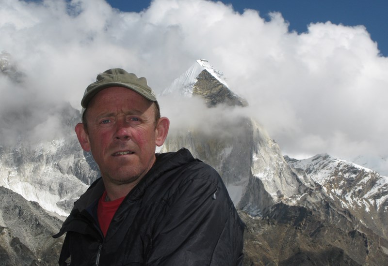 Picture of Simon with snow covered mountain behind him