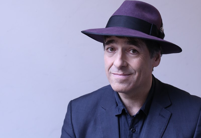 Mark Steel wearing purple hat