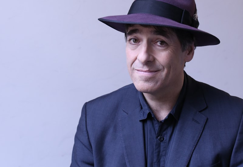 Mark Steel wearing purple hat