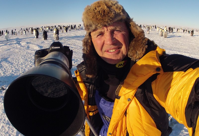 Doug Allen with penguins behind him