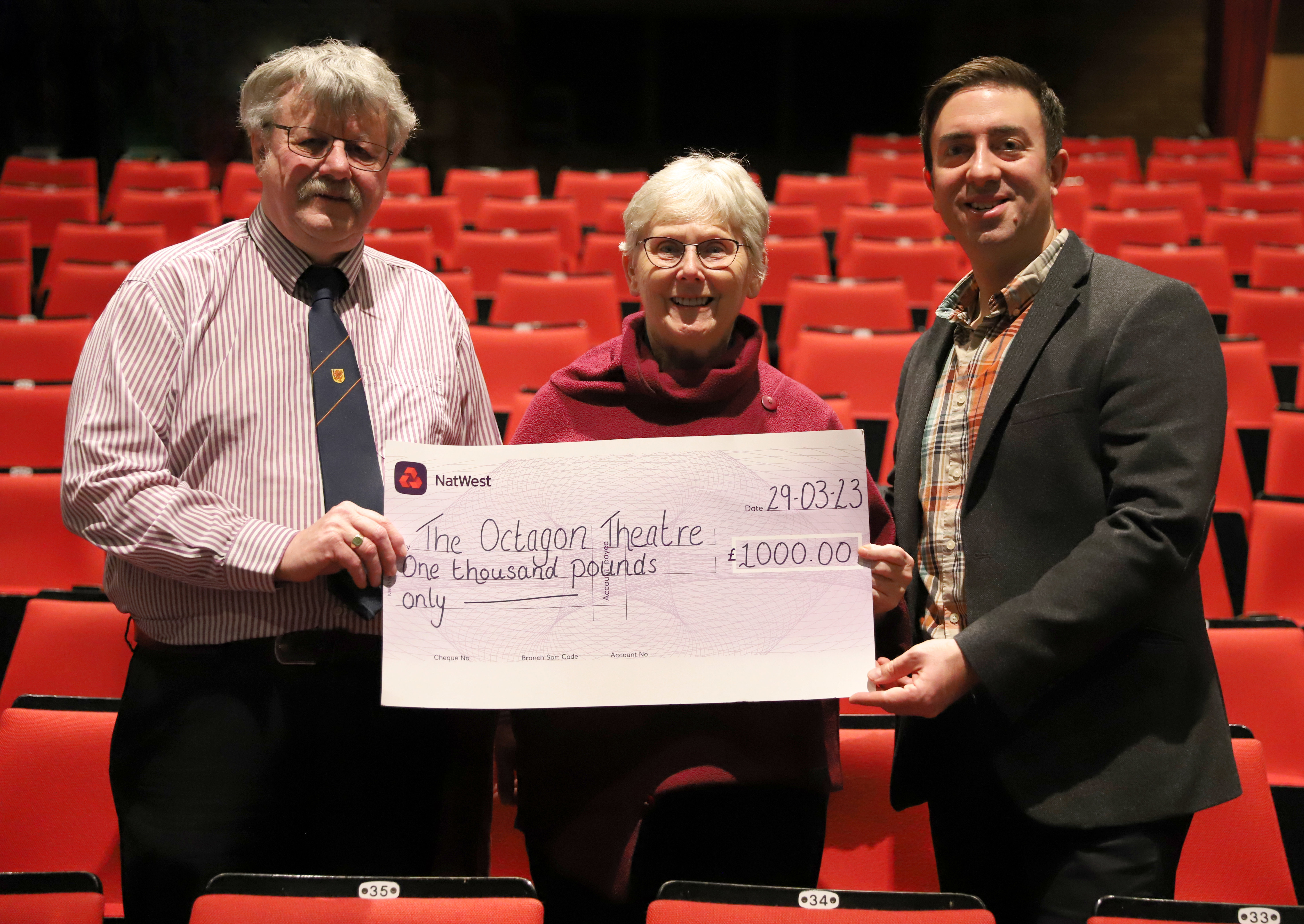 Liz Pike (middle) presents Adam Burgan (right) and Councillor Mike Best (left) a cheque totalling £1,000